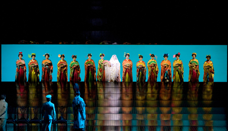 A number of women opera singers dressed as geishas in line on a stage